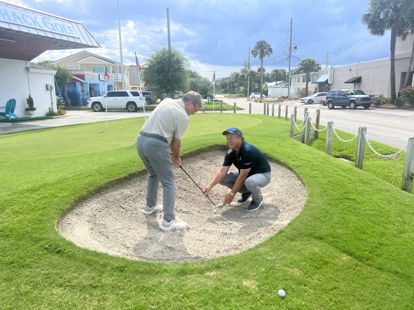 The sand trap beside the live putting green at Caddyshack golf and teaching center, used for lessons