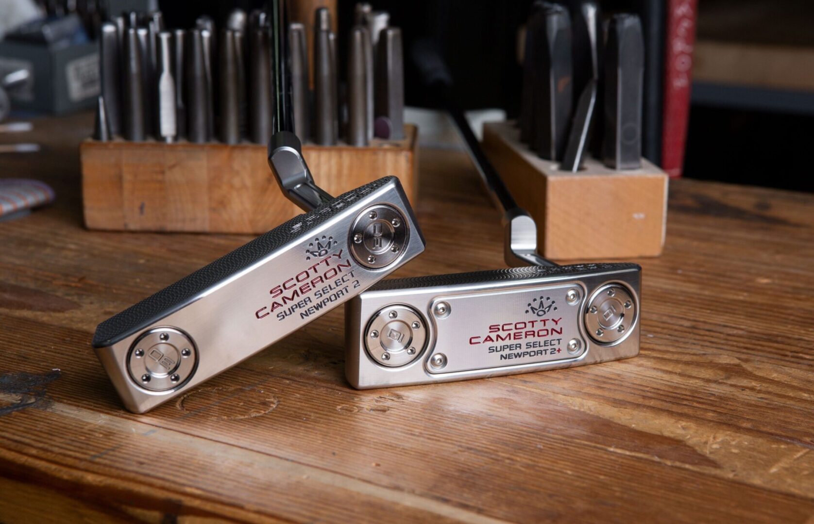 Scotty Cameron putter, laying down, showing bottom of Newport 2 and Newport 2+